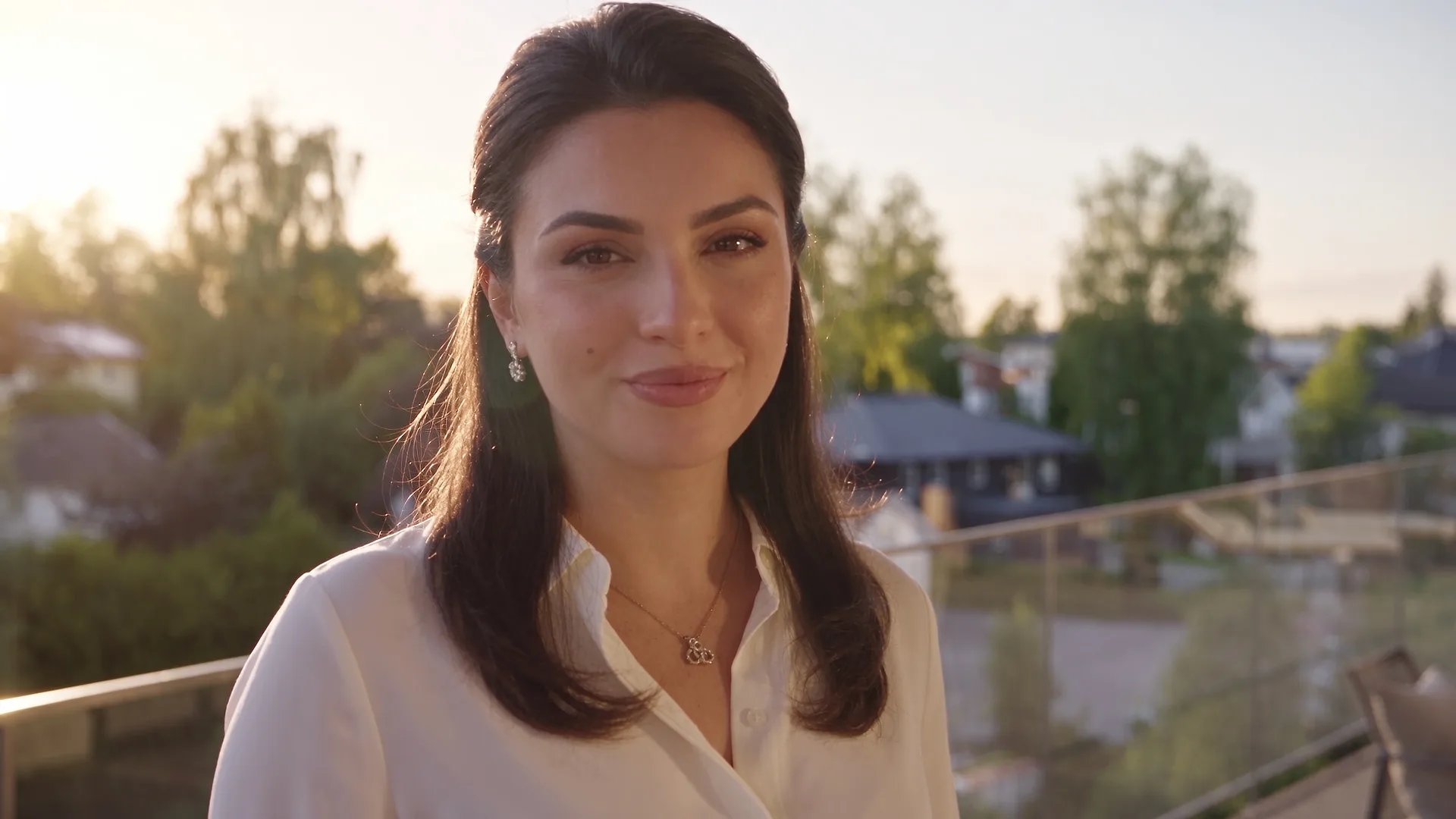 Leila, our virtual presenter, on a roof terrace at golden hour